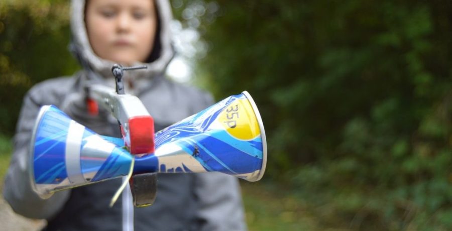 Child holding drinks can