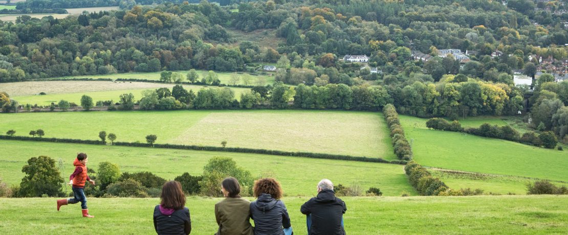 Photo of a family looking over the Surrey Countryside