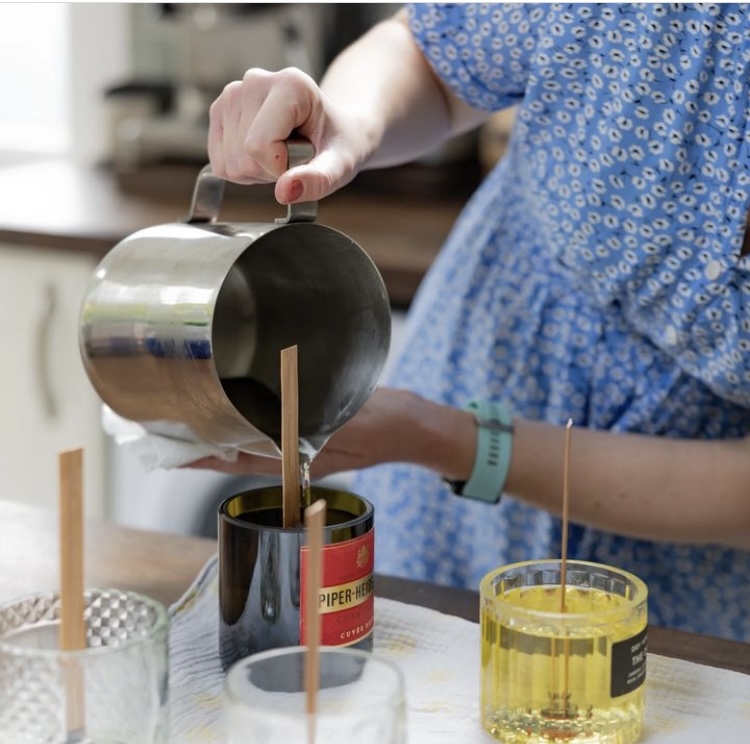 Image of wax being poured into upcycled glass bottle
