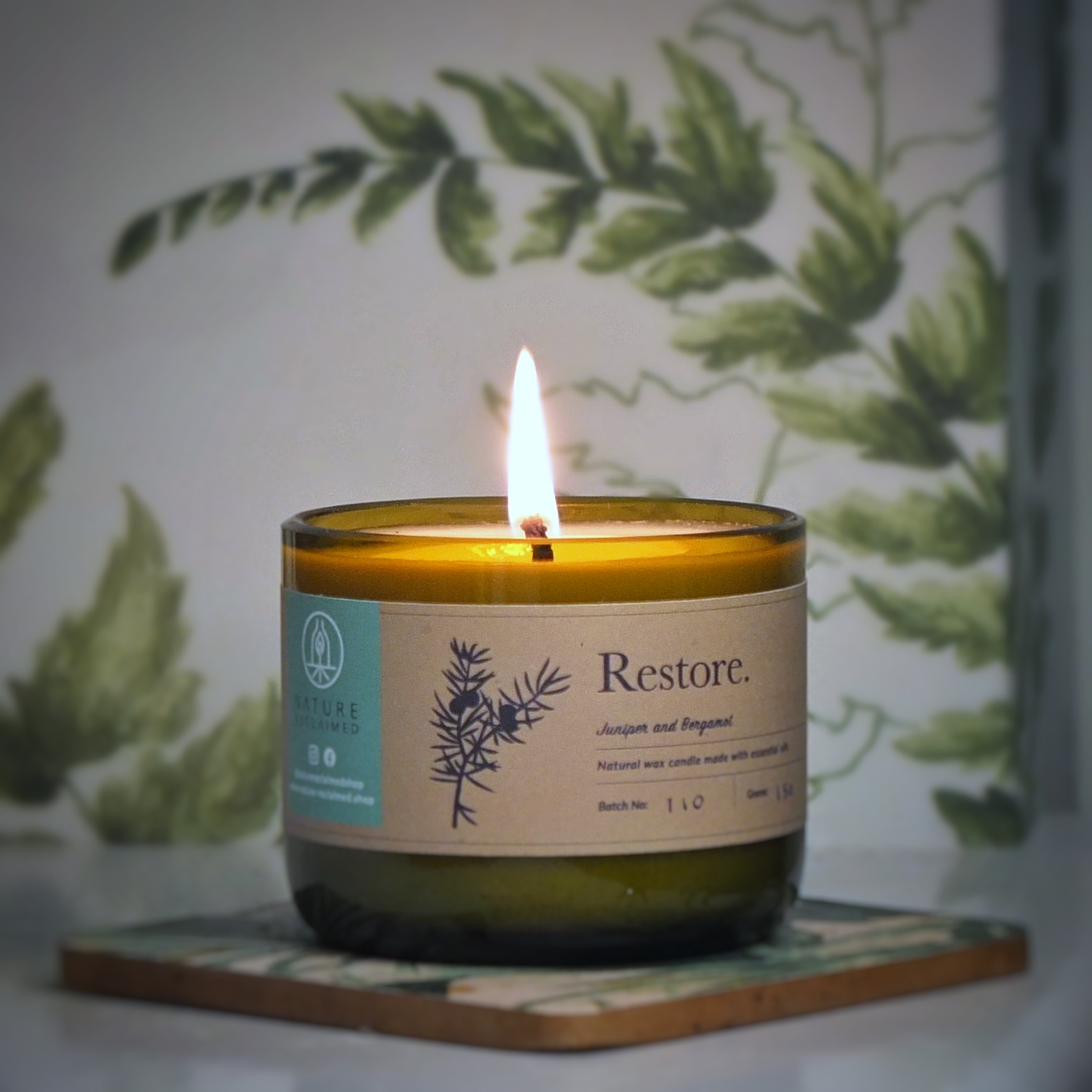 Image of lit upcycled green bottle candle