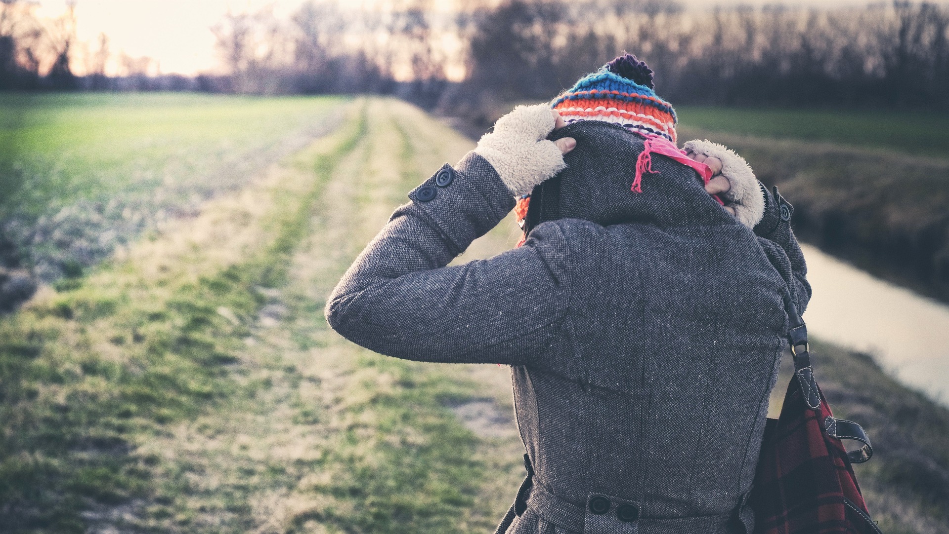 Woman putting on a warm hat