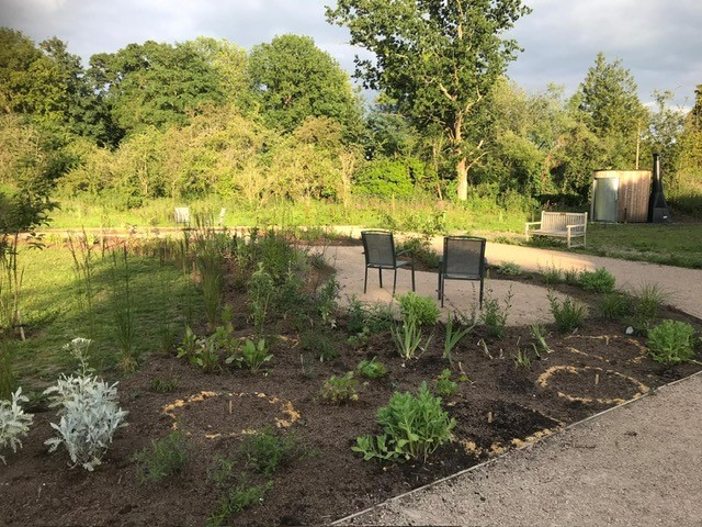 Image of Farncombe Community Garden with seating area in the centre