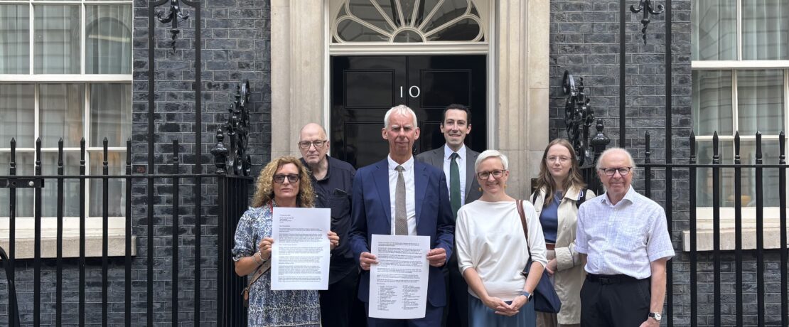 Image of campaigners ouside number 10 Downing Street to hand deliver a letter to Prime Minister Andy Burnham calling for amendment to the Civil Aviation Bill