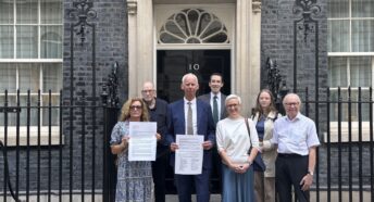 Image of campaigners ouside number 10 Downing Street to hand deliver a letter to Prime Minister Andy Burnham calling for amendment to the Civil Aviation Bill