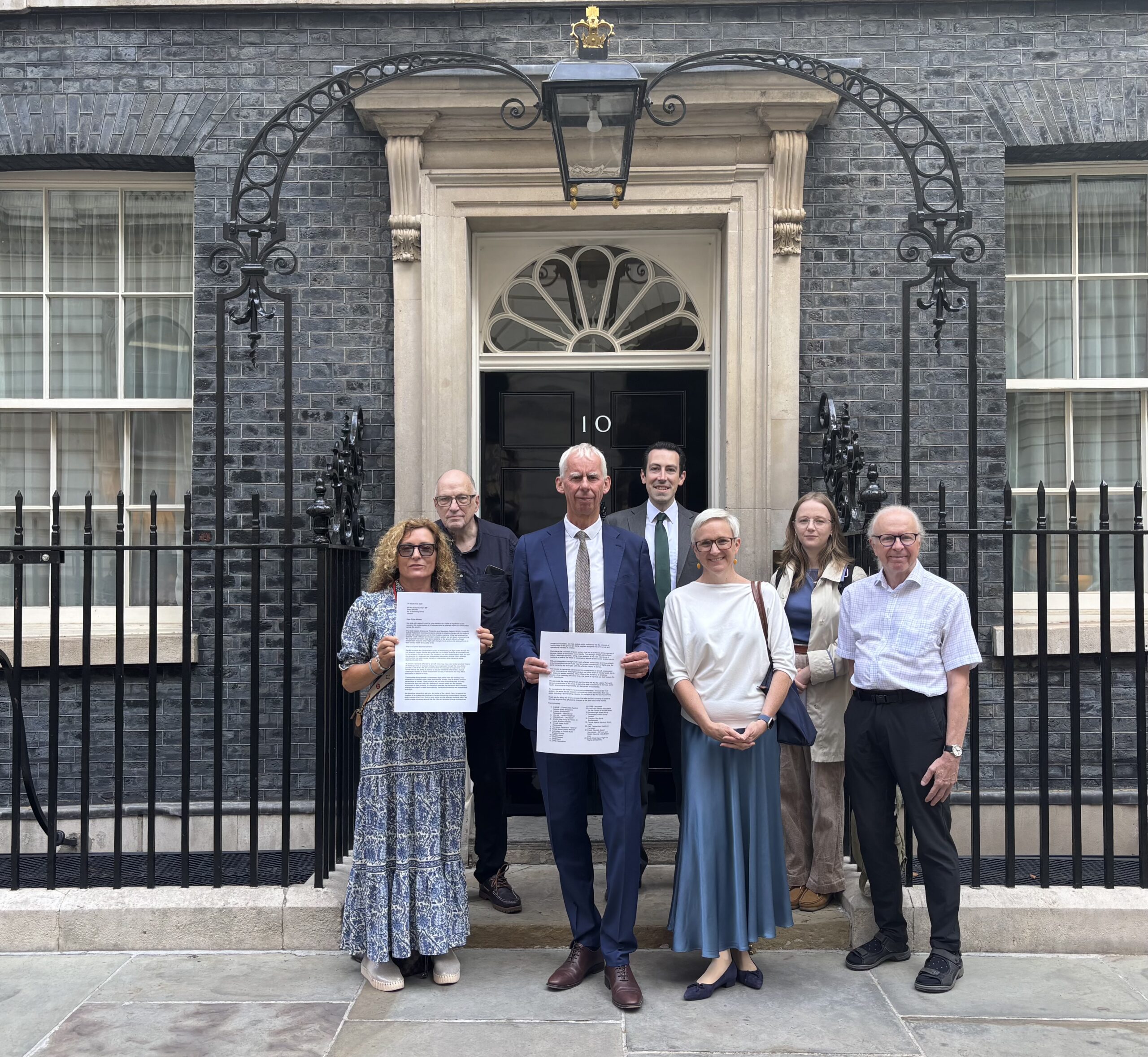 Image of campaigners ouside number 10 Downing Street to hand deliver a letter to Prime Minister Andy Burnham calling for amendment to the Civil Aviation Bill