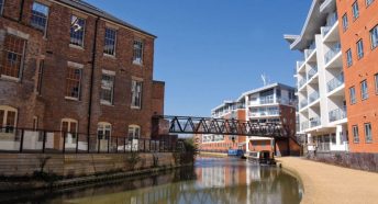 A combination of old and new buildings with a canal passing between them