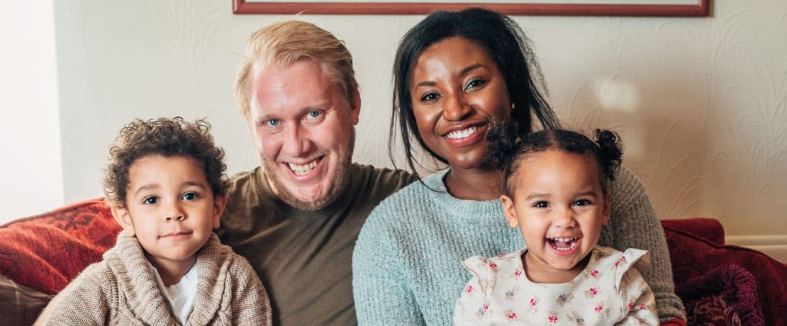 A family at home posing for a photograph