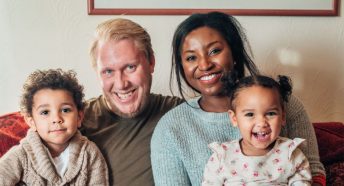 A family at home posing for a photograph