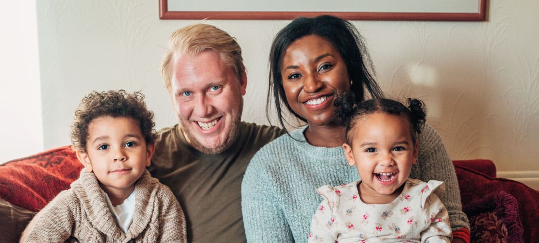 A family at home posing for a photograph