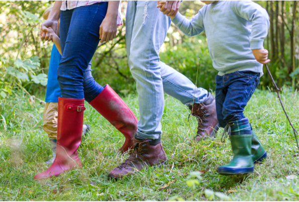 Four people's feet walking in outdoor shoes