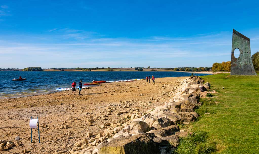 Kayakers in bright clothes on a beach