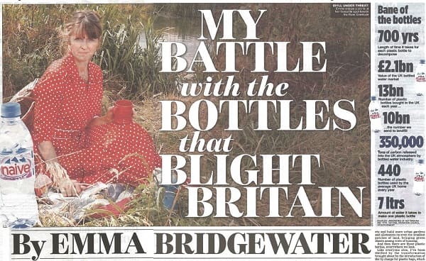 A newspaper clipping showing a woman seated outdoors among plastic bottles