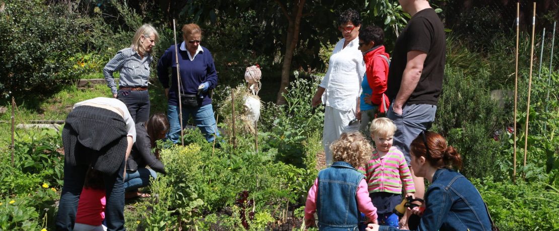 Adults and children in a community garden