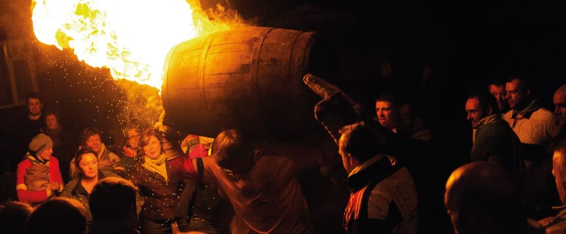 Man carrying flaming barrel