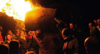 Man carrying flaming barrel