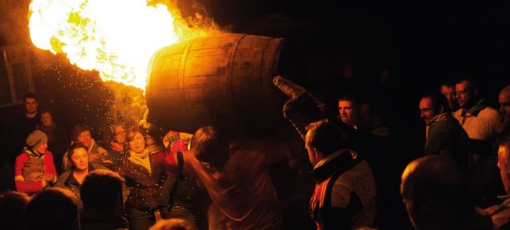 Man carrying flaming barrel