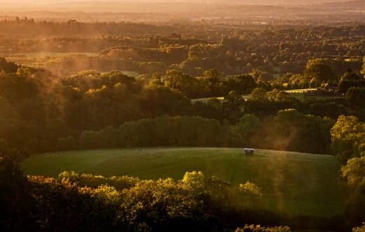 A warm sunset light across rolling hills