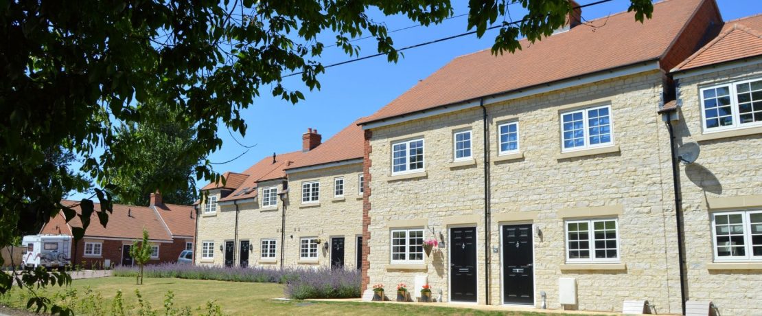 A row of limestone new-build cottages