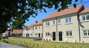 A row of limestone new-build cottages