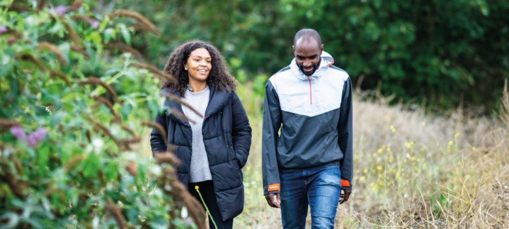 Couple walking through tall grass