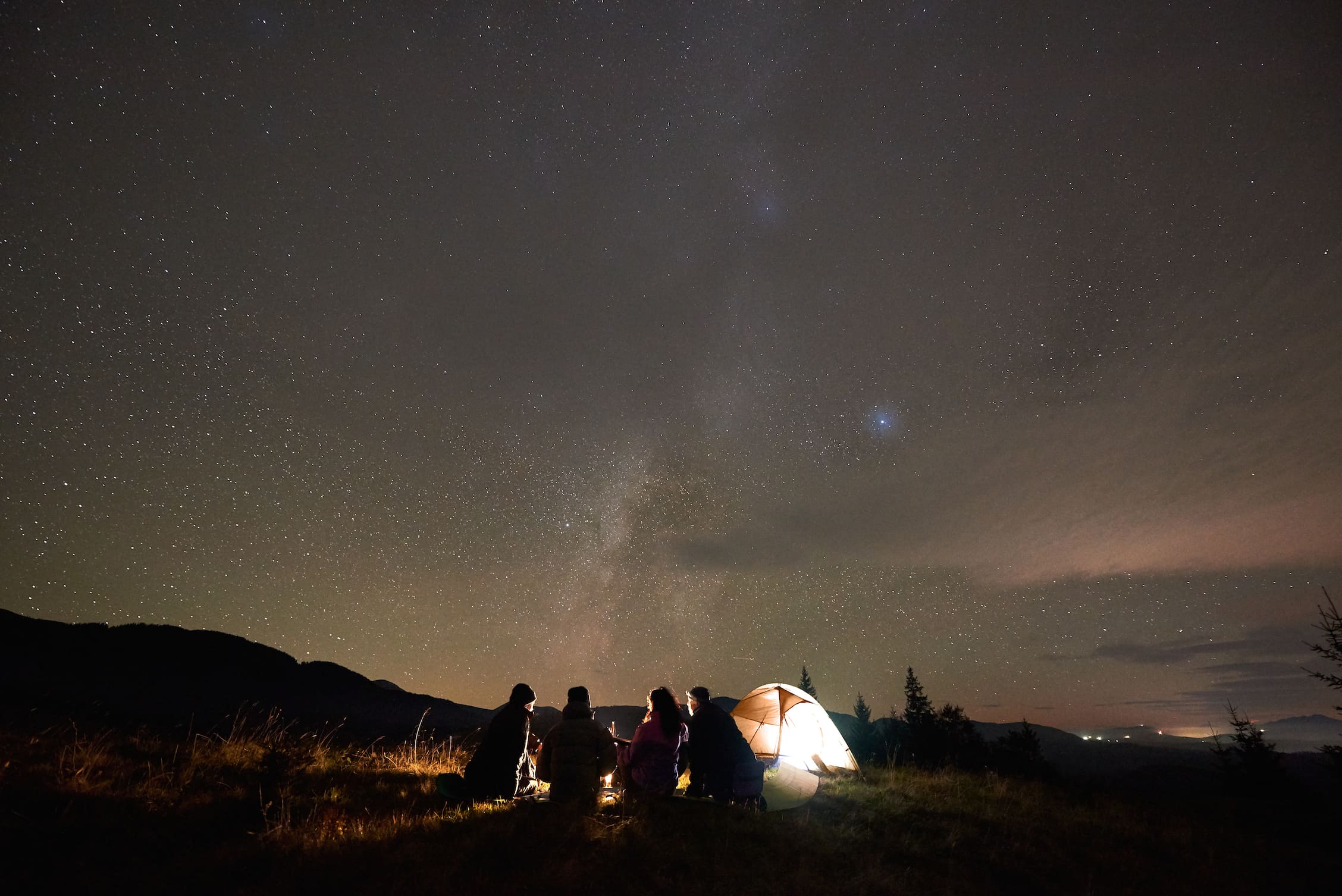 Camping under a starry night sky