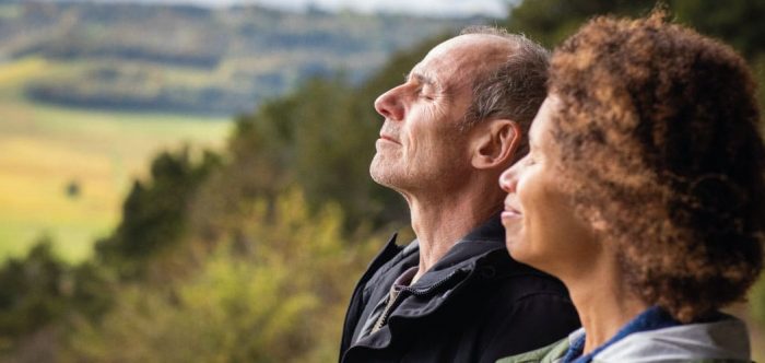 Couple enjoying peace and quiet with a countryside view behind them