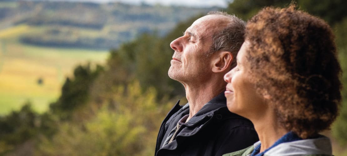 Couple enjoying peace and quiet with a countryside view behind them