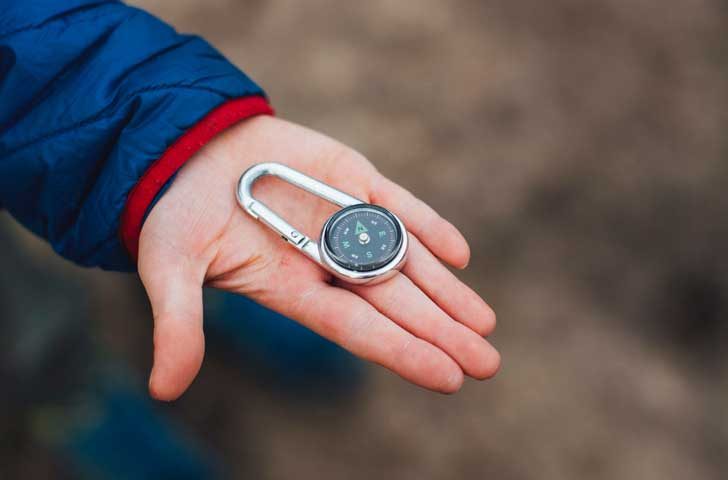 Hand holding a compass