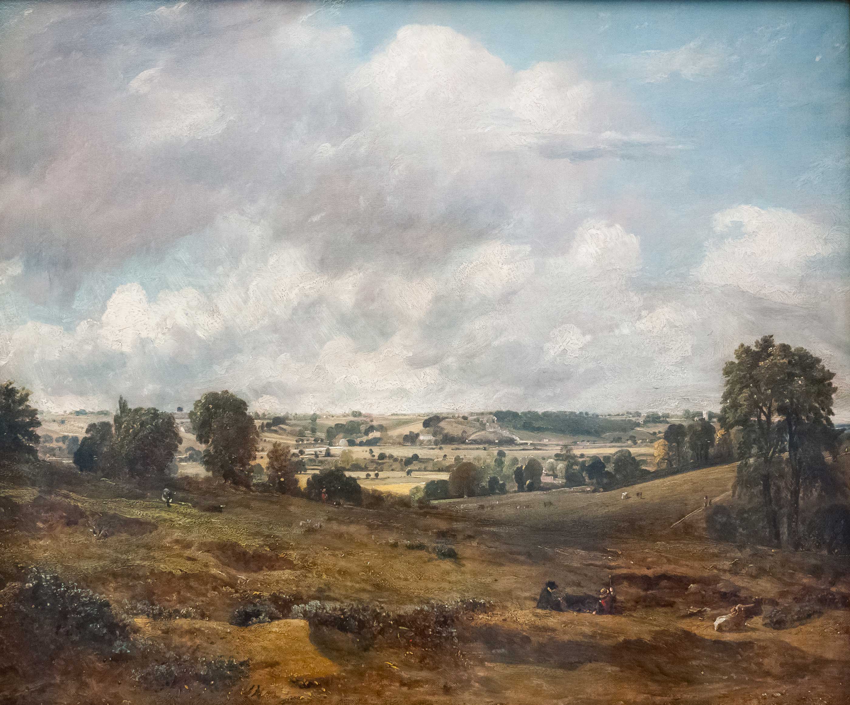 An oil painting showing a pastoral valley and blue cloudy skies