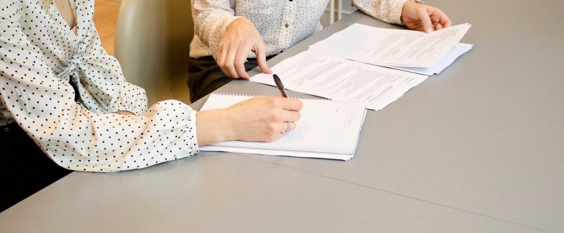 Women looking at documents in an office setting