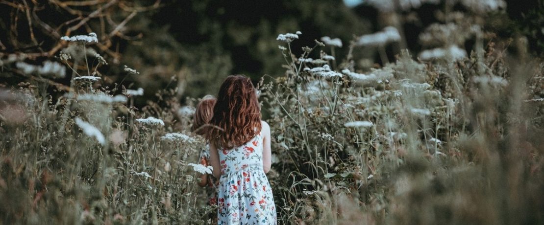 Girl walking through cow parsley