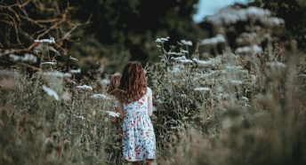 Girl walking through cow parsley