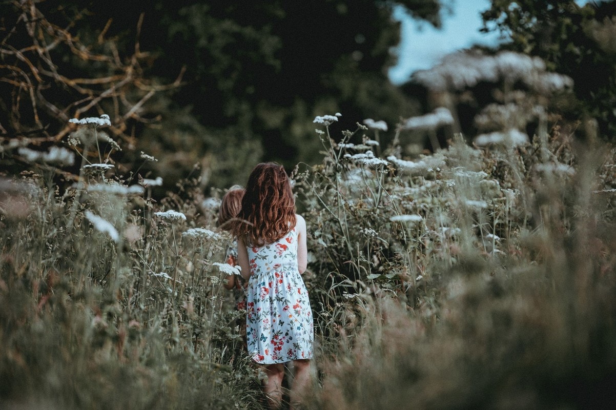 Girl walking through cow parsley