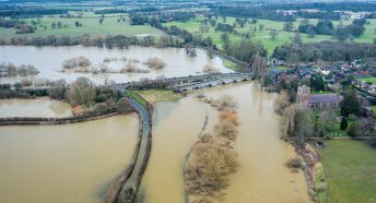 Flooded countryside scene with brown water covering fields