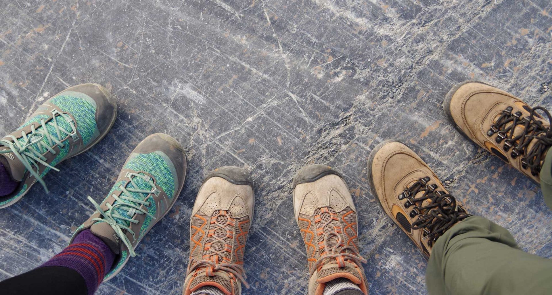 Three pairs of hiking boots pointing inwards
