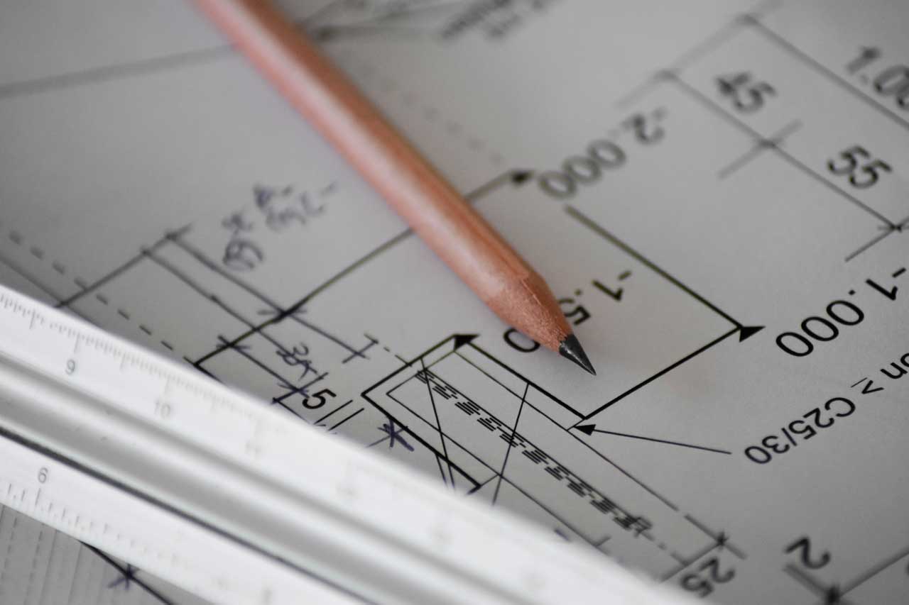 A pencil lying on an architect's blueprint