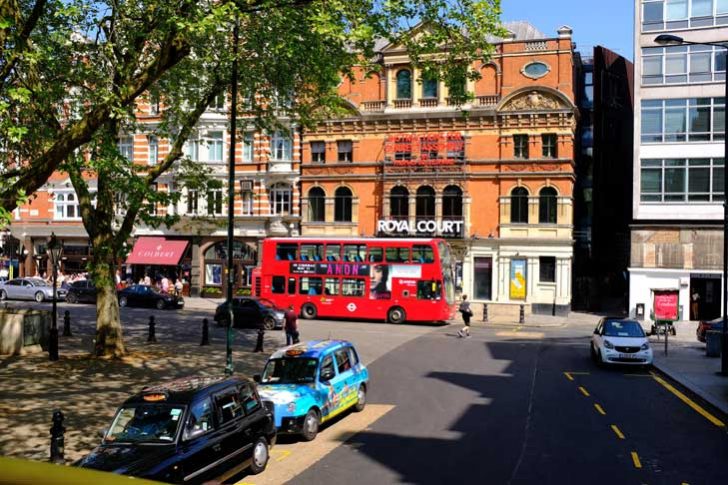 A red brick theatre building frontage on a busy street