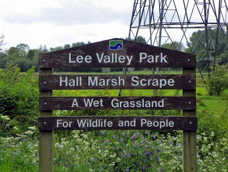 A wooden sign announcing a park for wildlife and people