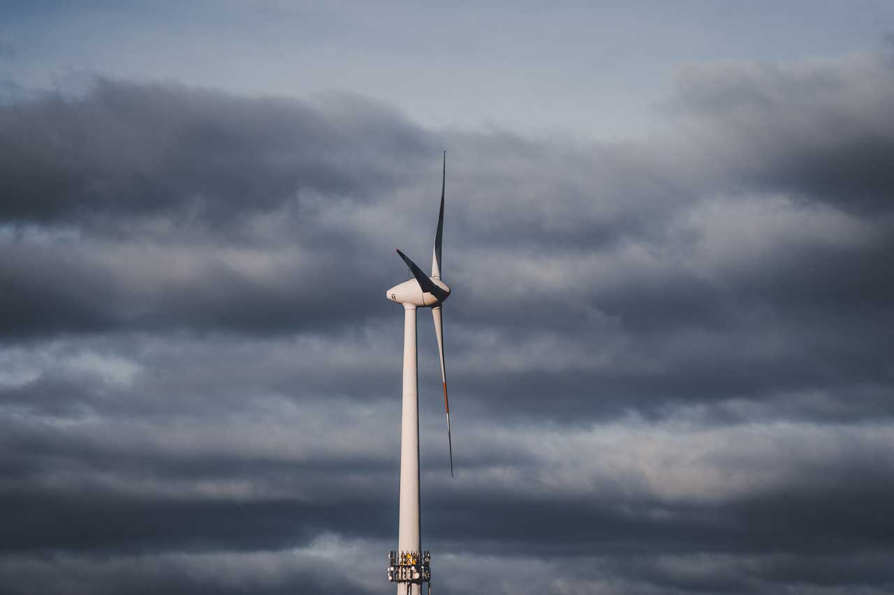 A wind turbine against a cloudy sky