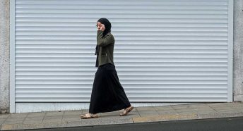 A woman walks on a street