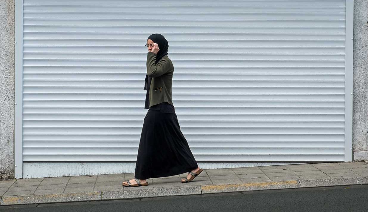 A woman walks on a street