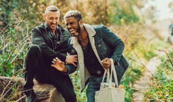 Two men laugh on an autumn walk