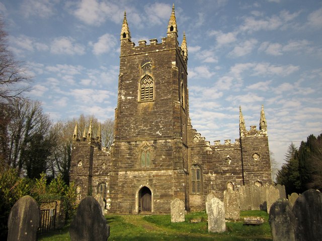 A rural church and gravestones with a blue sky behind