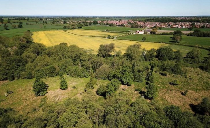 Aerial view of countryside with houses in the distance