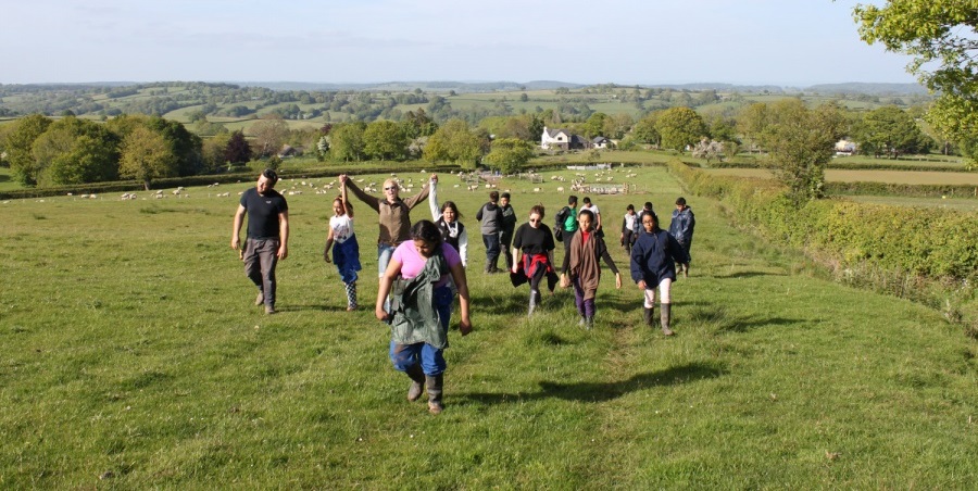 a group of young people walking in the countryside