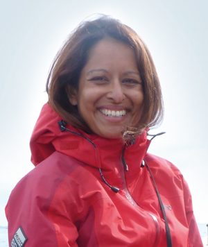 A smiling woman in a red anorak