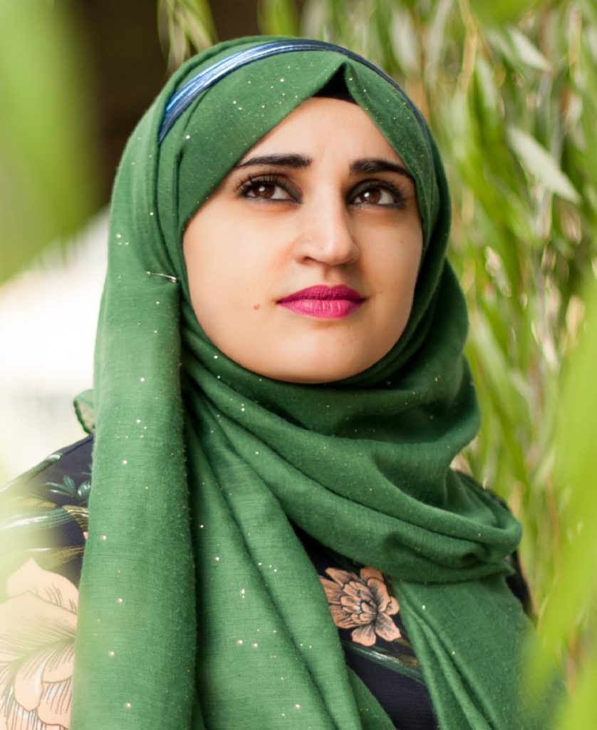 Head and shoulders image of woman in green headscarf