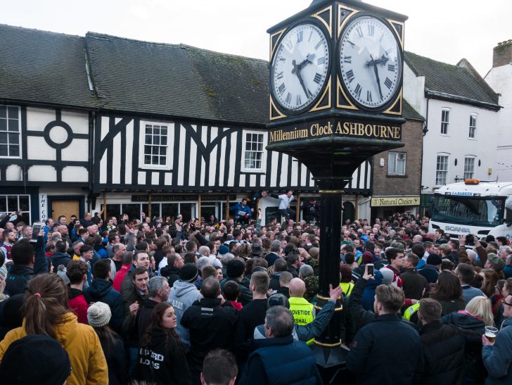 Clock and crowd ready to play Shrovetide football in Ashbourne, Derbyshire