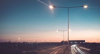 A motorway lit by streetlights at night