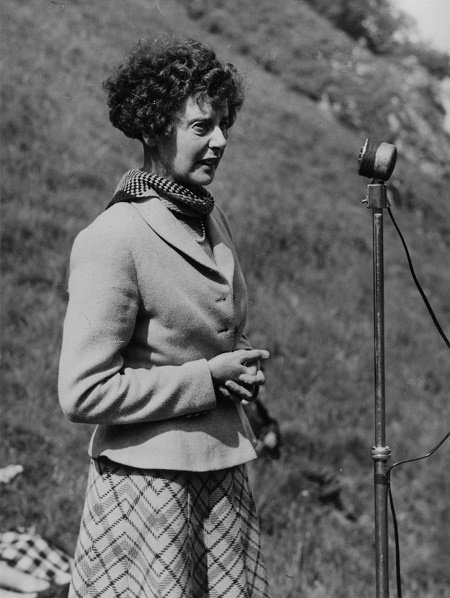 A woman speaking at an outdoor event